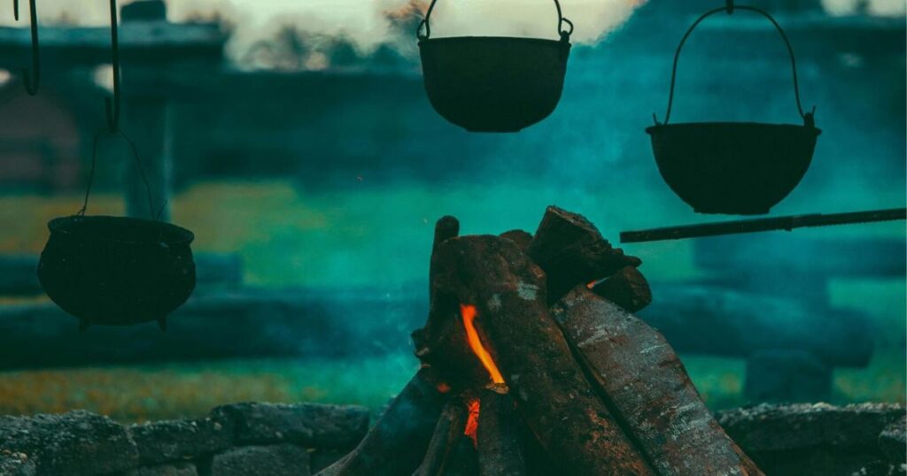 Cauldrons hung over a campfire illustrate the concept of childhood dreams. 