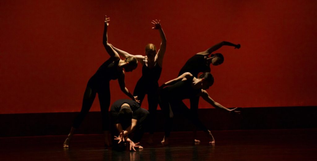 Five women dancers are shown against a red background, demonstrating the beauty of the living body and Jung's ideas about embodiment.