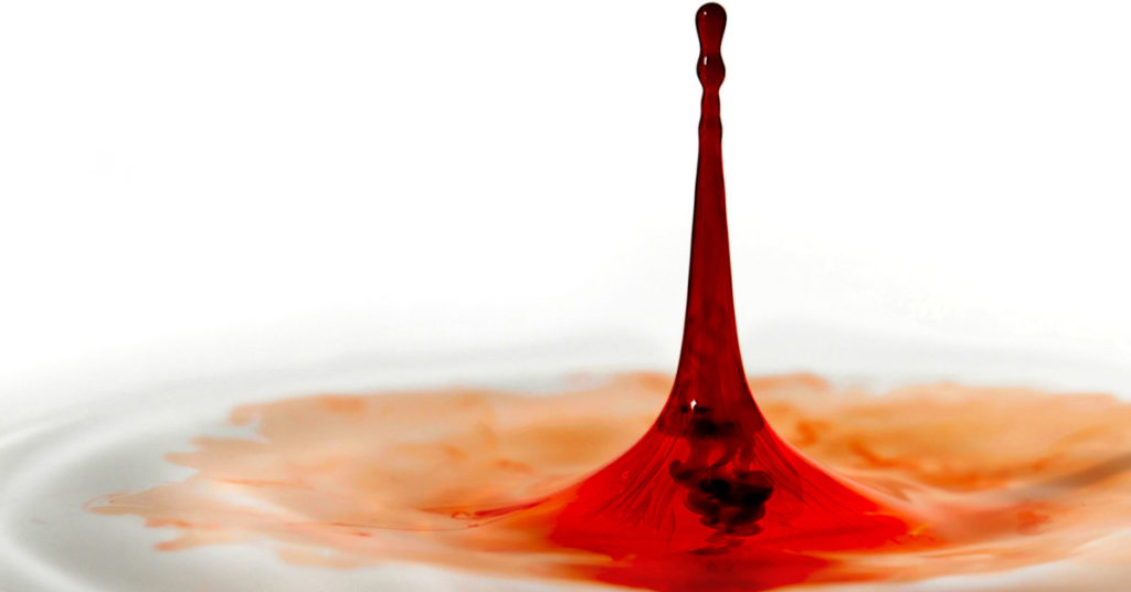 a red drop enters some pure liquid, illustrating pollution and purity.